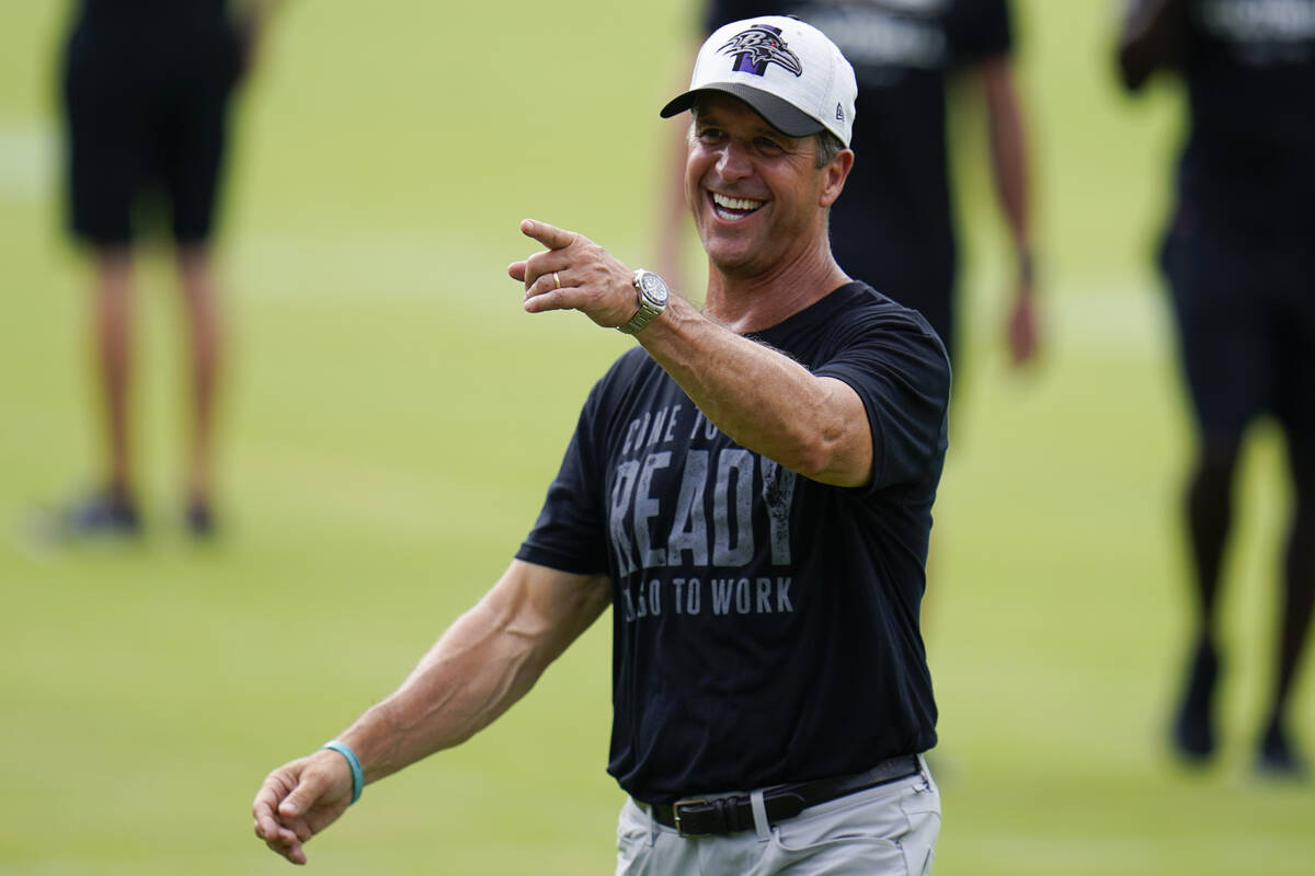 Baltimore Ravens head coach John Harbaugh reacts during the team's NFL football training camp, ...